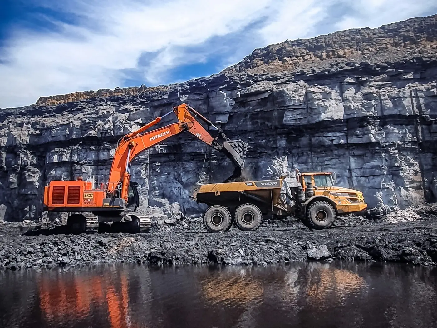 Excavator loading a tipper lorry in a quarry